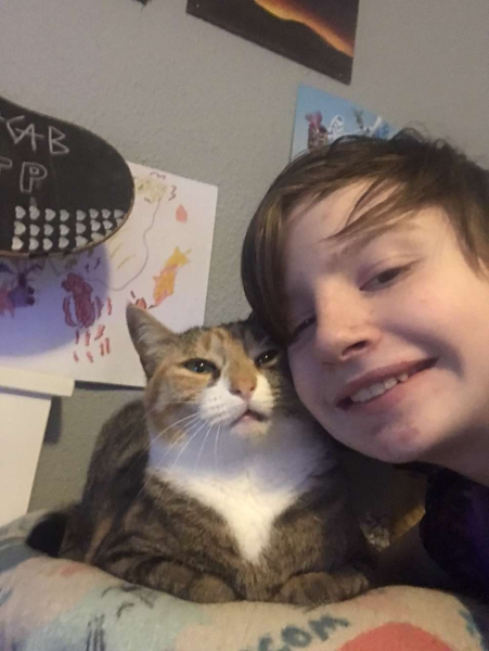 Silus smiling while holding Kitterson.